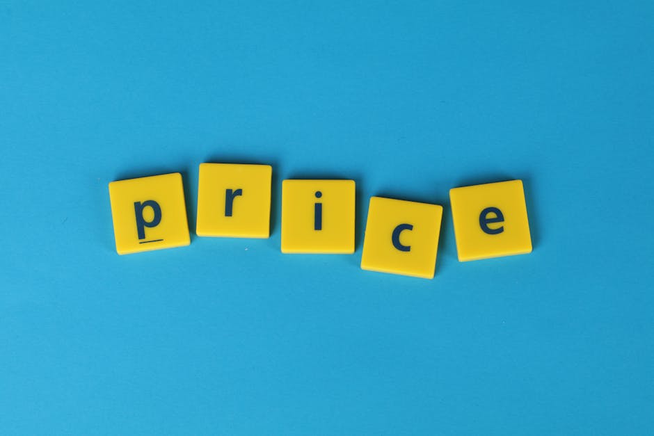 A close-up photograph of five yellow rectangular blocks with black lowercase letters spelling the word 'price' arranged in a slightly curved line on a bright blue background. The blocks have a matte f